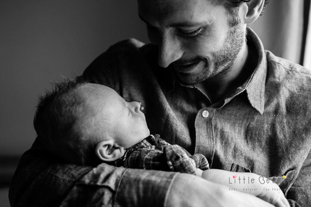 photograph of special moment with daddy and newborn baby