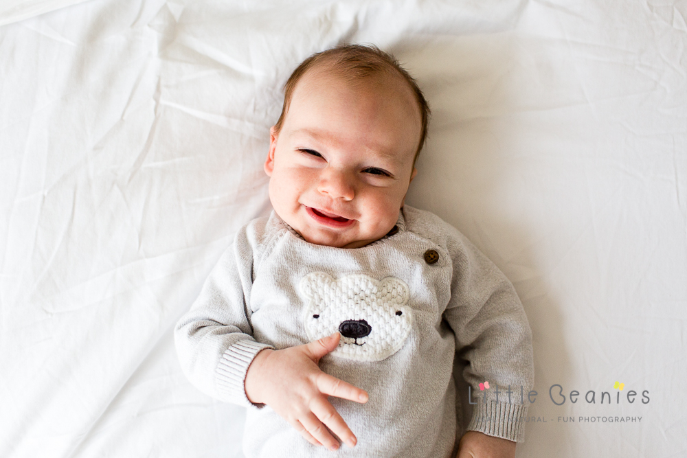 carrie greens baby boy kasey on bed laughing