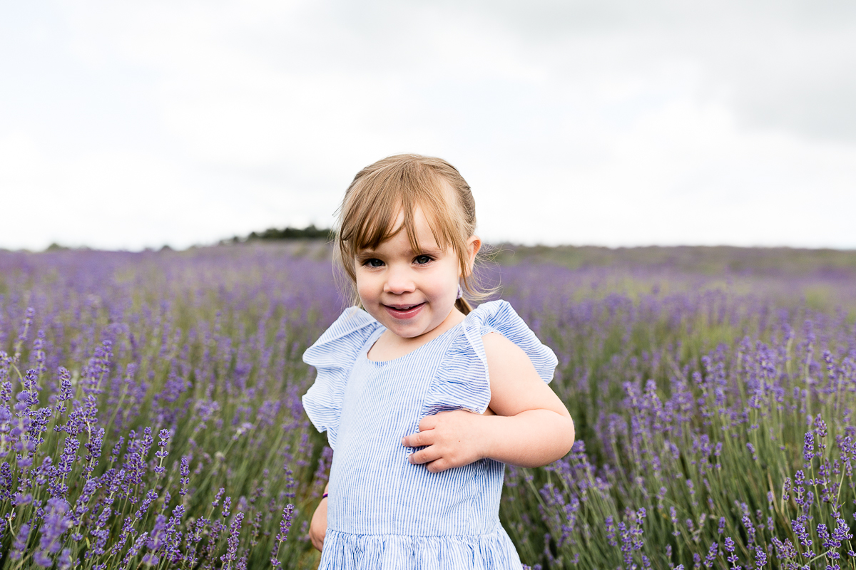 girl in field running through in lavender field