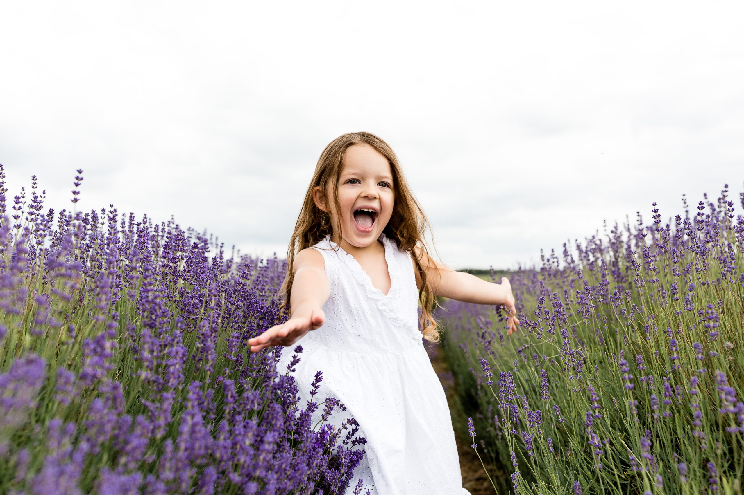 girl running through lavender