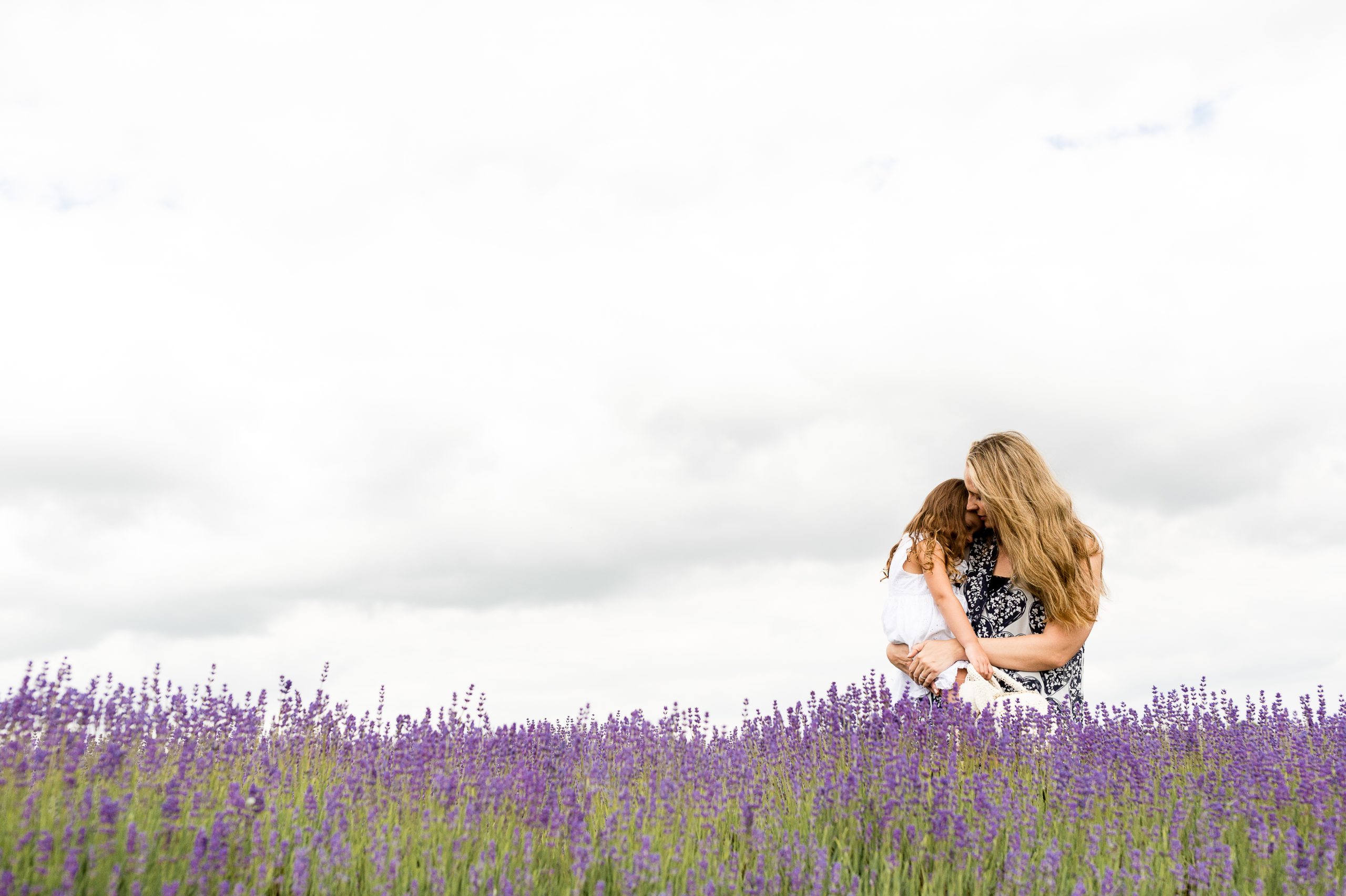 mum and daughter as hugging in the field
