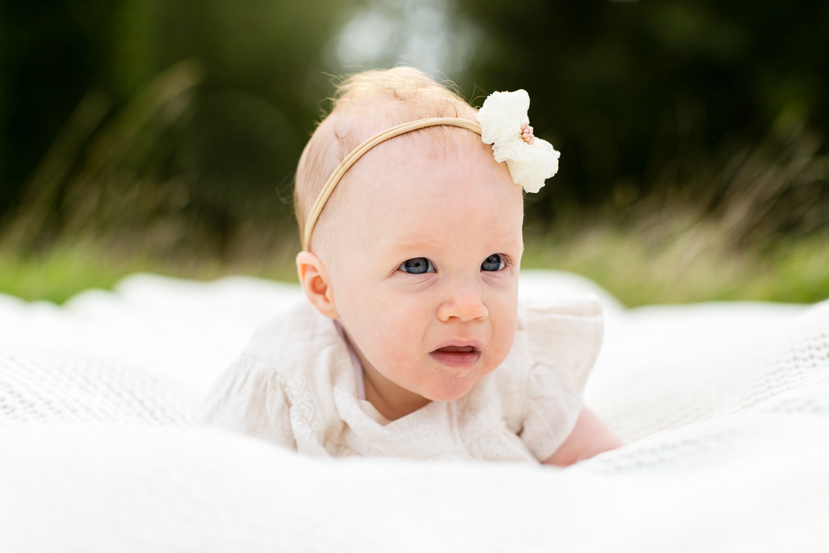 gorgeous baby girl in the park in knowle having picture taken.