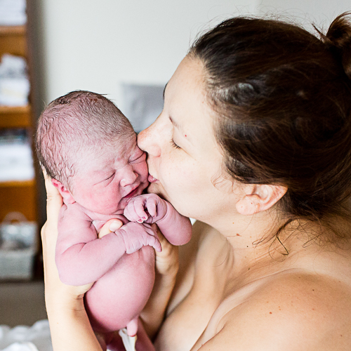 mum with baby kissing after she has just given birth