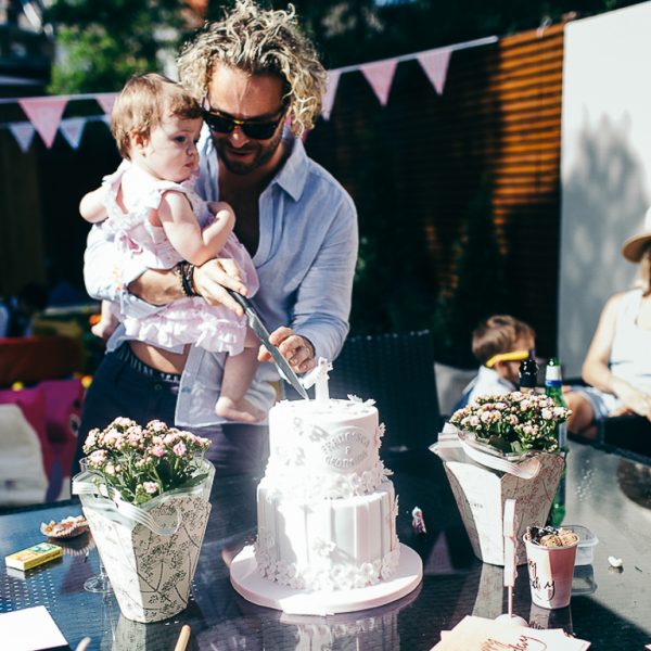 man cutting daughters birthday cake
