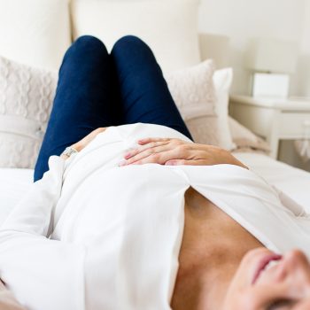 woman lying on bed relaxing at 33 weeks pregnant