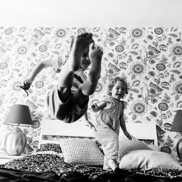 kids having fun jumping on bed